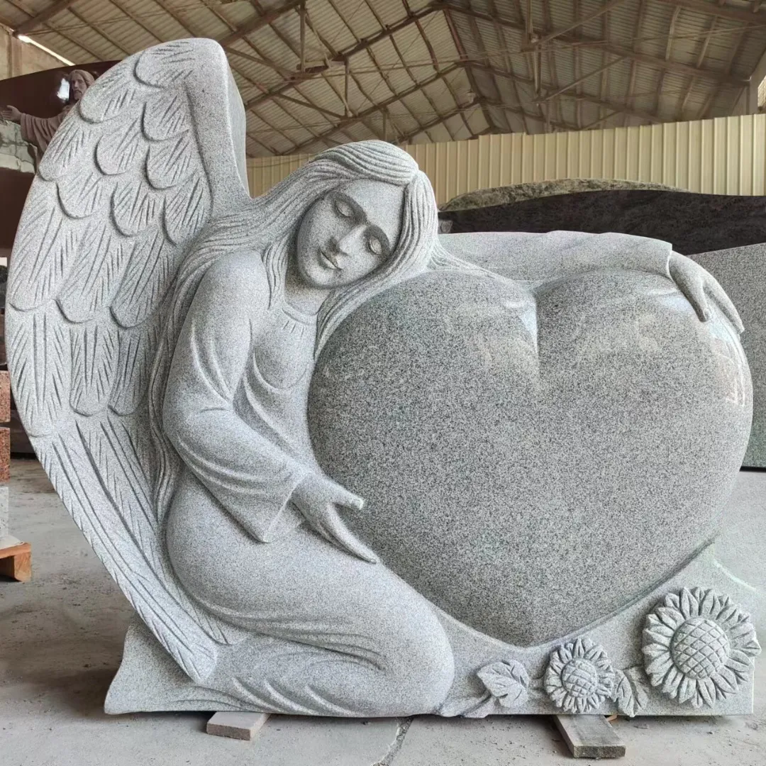 Carved granite angel resting against a polished heart