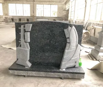 Blue-green granite upright with carved scrollwork