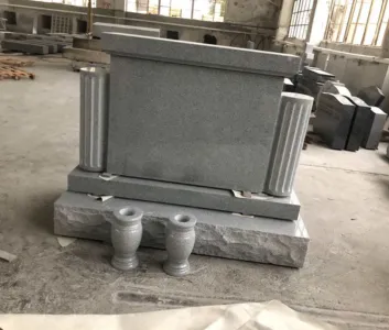 Grey upright memorial with columns and matching vases